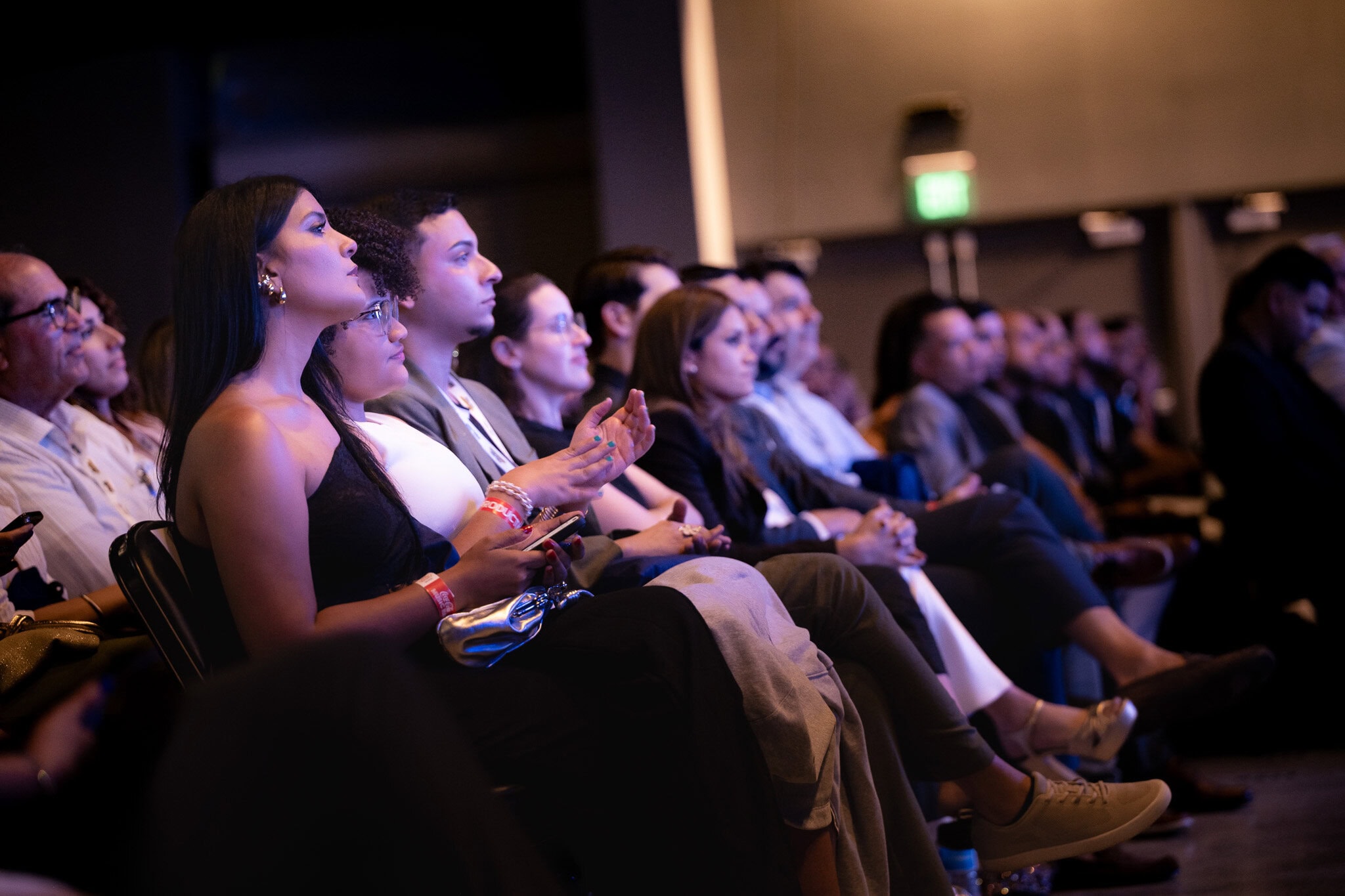 Audience members listening and reacting during business conference