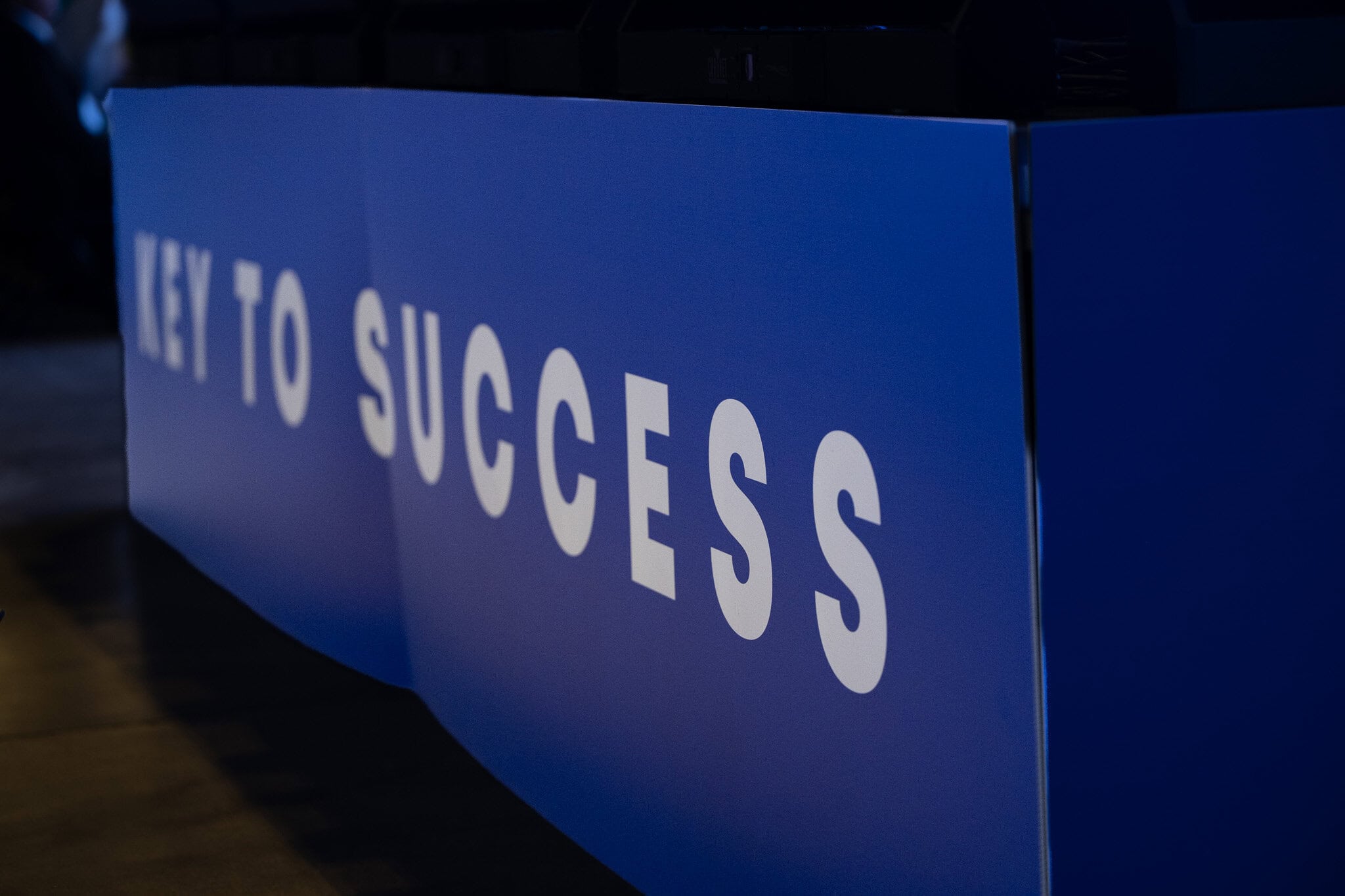 Key to Success event branding displayed on blue panel