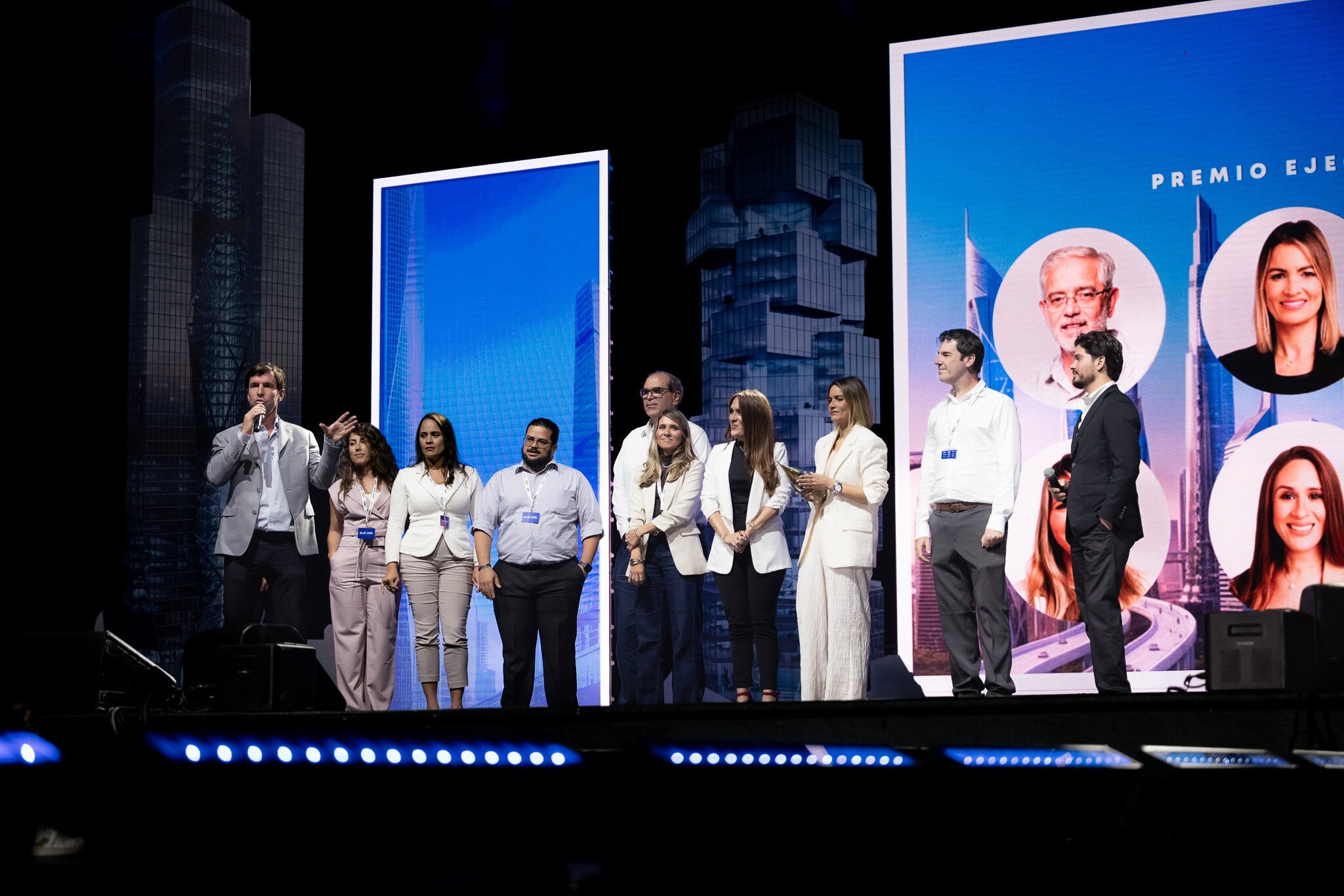 Leadership team standing on stage during business event